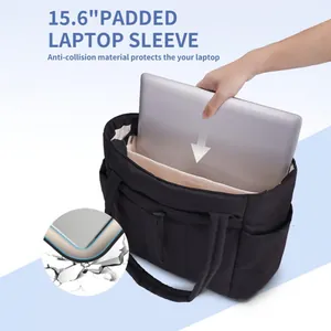 Close-up of padded 15.6-inch laptop compartment inside a black quilted tote bag