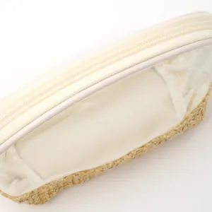 Top view detail of waterproof straw makeup bag with transparent PVC lid and zipper.