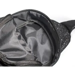 Close-up detail showing the inner lining and storage space of black glitter chest bag