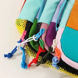 Close-up of vibrant dopamine-colored nylon storage bag zippers and textured mesh detail