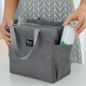 Close-up detail of the side pocket on a gray insulated lunch bag holding a soda can