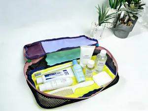 Organized internal view of a waterproof nylon travel toiletry bag with vibrant dopamine colors