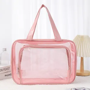 Close-up of pink transparent mesh toiletry bag with durable handles and zipper