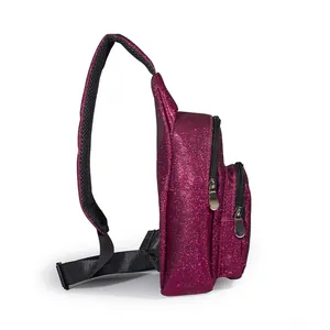 Side profile of a sparkling fuchsia glitter crossbody chest bag with multiple zip pockets.
