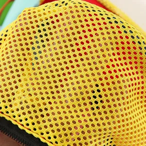 Close-up macro view of vibrant yellow nylon mesh texture on a travel storage pouch.