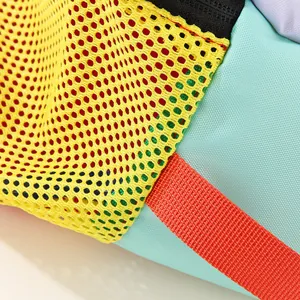 Close-up of vibrant nylon fabric and yellow mesh on a waterproof storage bag.