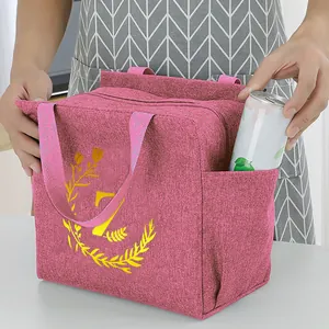 Detailed view of the pink portable insulated lunch bag with a drink can in the side pocket