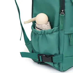 Detailed view of green travel backpack side pocket with a beige folded umbrella