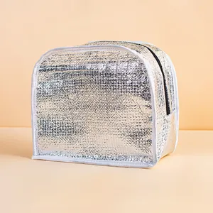 Detailed view of silver aluminum foil insulated lunch bag with secure zipper and white piping