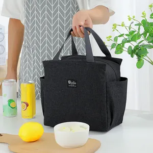 Large capacity black insulated lunch bag with handles shown in a kitchen setting