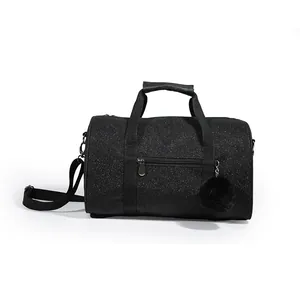 Black glitter yoga dance duffel bag featuring top handles and a plush pom-pom charm
