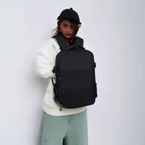 Professional view of a black large capacity travel backpack on a model for size comparison