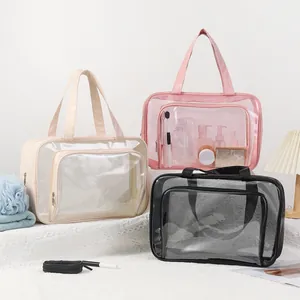 Detail shot of large capacity transparent mesh toiletry bags in pink, beige, and black colors.