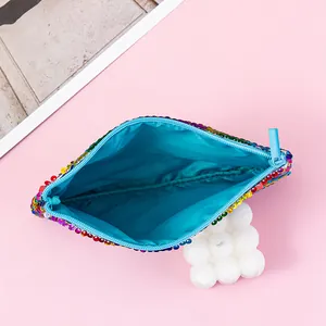 Inside view of colorful mermaid sequin pouch with bright blue lining