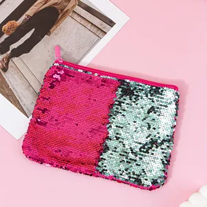 Detailed view of reversible pink and silver mermaid sequin pouch with pink zipper.