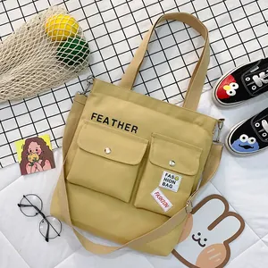 Yellow canvas crossbody tote bag with front pockets for students, large capacity daily bag