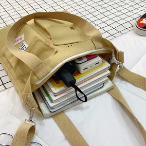 Yellow canvas tote bag with multi pockets and wide shoulder strap
