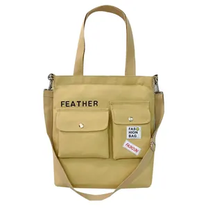 Large capacity yellow canvas tote bag with front pockets and adjustable shoulder strap