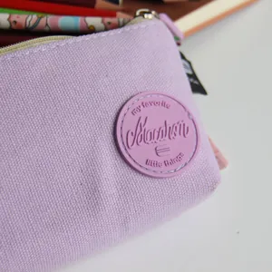 Detail shot of Morandi purple canvas pencil case featuring an embossed rubber patch