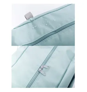 Detail showing water-resistant mint fabric and double zipper on travel storage bag