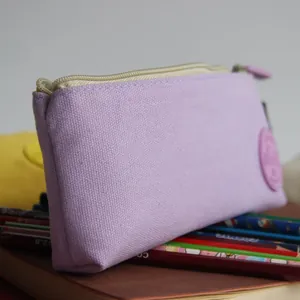 Detailed close-up of a light purple canvas pencil pouch with aesthetic stationery props