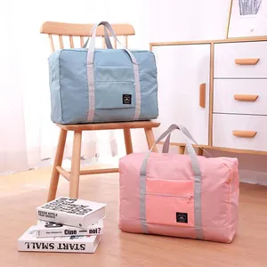 Large capacity foldable travel duffel bags in blue and pink for organized trips