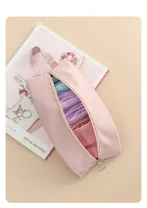 Detailed view of a pink waterproof travel storage bag filled with organized garments