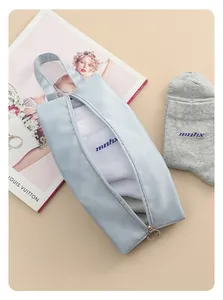 Detailed view of a portable light blue waterproof travel storage bag filled with socks