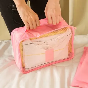 Pink travel luggage organizer bag featuring breathable mesh and a sturdy carry handle for suitcase