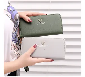 Detailed view of two long zip-around wallets in olive green and light grey colors