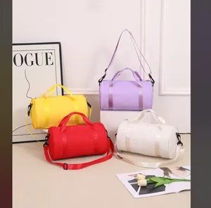 Collection of colorful waterproof cylindrical sports bags for gym and dance storage.