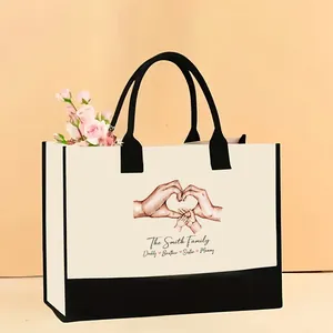 Bolso tote de lona de gran capacidad con un estampado familiar de manos en corazón