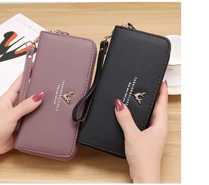 Detailed view of women's long zip-around wallets with lychee texture and deer emblem