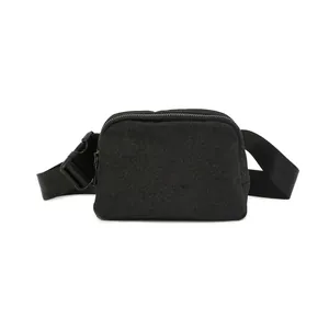 Close-up detail of the black glitter fabric waist bag with an adjustable strap and buckle.