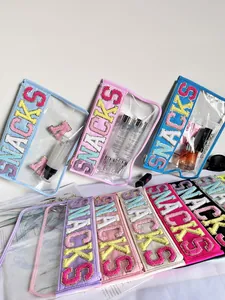 Detailed view of colorful PVC storage bags with embroidered SNACKS lettering