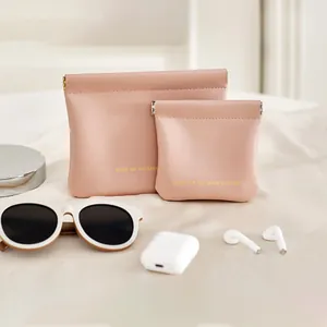 Detailed lifestyle view of pink faux leather pouches with automatic shrapnel closure