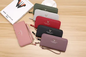 Selection of colorful women's long zipper wallets with litchi grain texture on wooden desk