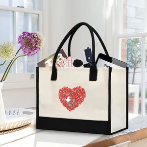 Canvas tote bag with floral heart print filled with everyday essentials on a table