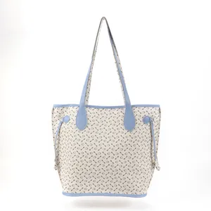 Front view detail of a large capacity printed tote bag with light blue straps and trim