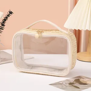 Elegant transparent cosmetic bag with straw-woven base and dual golden zippers for travel