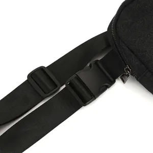 Close-up detail of the adjustable nylon strap and plastic buckle on the black glitter waist bag.