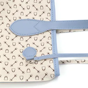Close-up detail of women's equestrian printed tote bag with blue trim and stirrup pattern