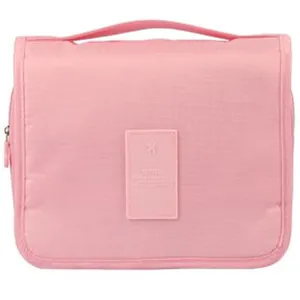 Front detail view of pink portable travel toiletry bag featuring a zipper and handle