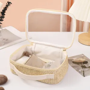 Straw woven makeup bag detail showing interior storage and transparent lid