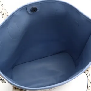 Close-up view of the spacious blue lining interior of a printed tote bag with magnetic closure