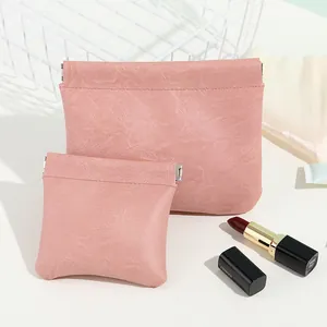 Two pink faux leather storage pouches with automatic spring closure for cosmetics.