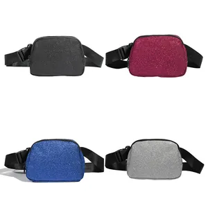 Detail view of glitter waist bags in four sparkling colors: black, red, blue, and silver.