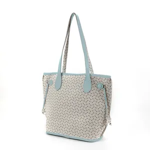 Angled detail view of a stylish women's large capacity tote bag with geometric print