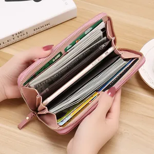 Pink litchi pattern women's long zipper wallet showing large capacity and card slots