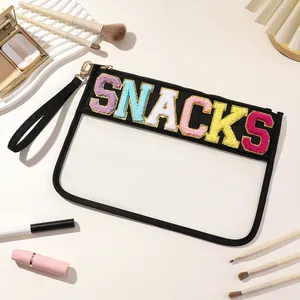 Close-up of clear PVC storage pouch with colorful chenille SNACKS letters